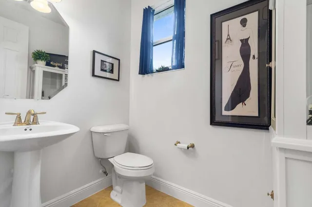 a white toilet sitting next to a bathroom sink