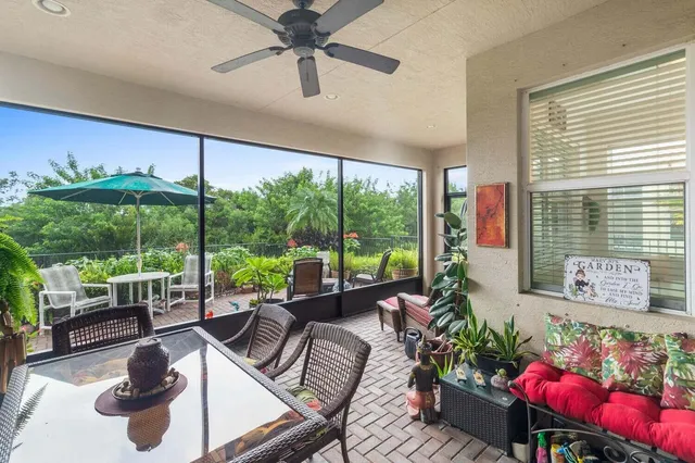 a living room with furniture and a floor to ceiling window
