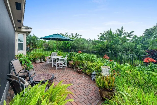 a view of a chair and table in the garden