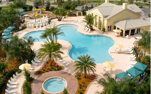 an aerial view of a house with swimming pool and outdoor space