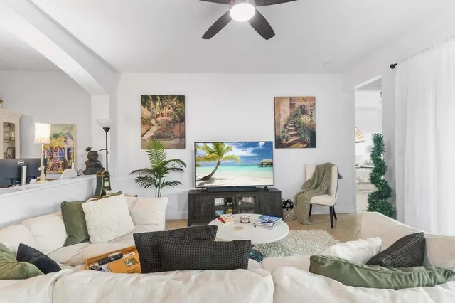 a living room with furniture and a wooden floor