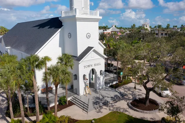 a view of house with a yard and potted plants