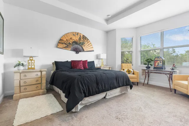 a bedroom with a large bed and a large window