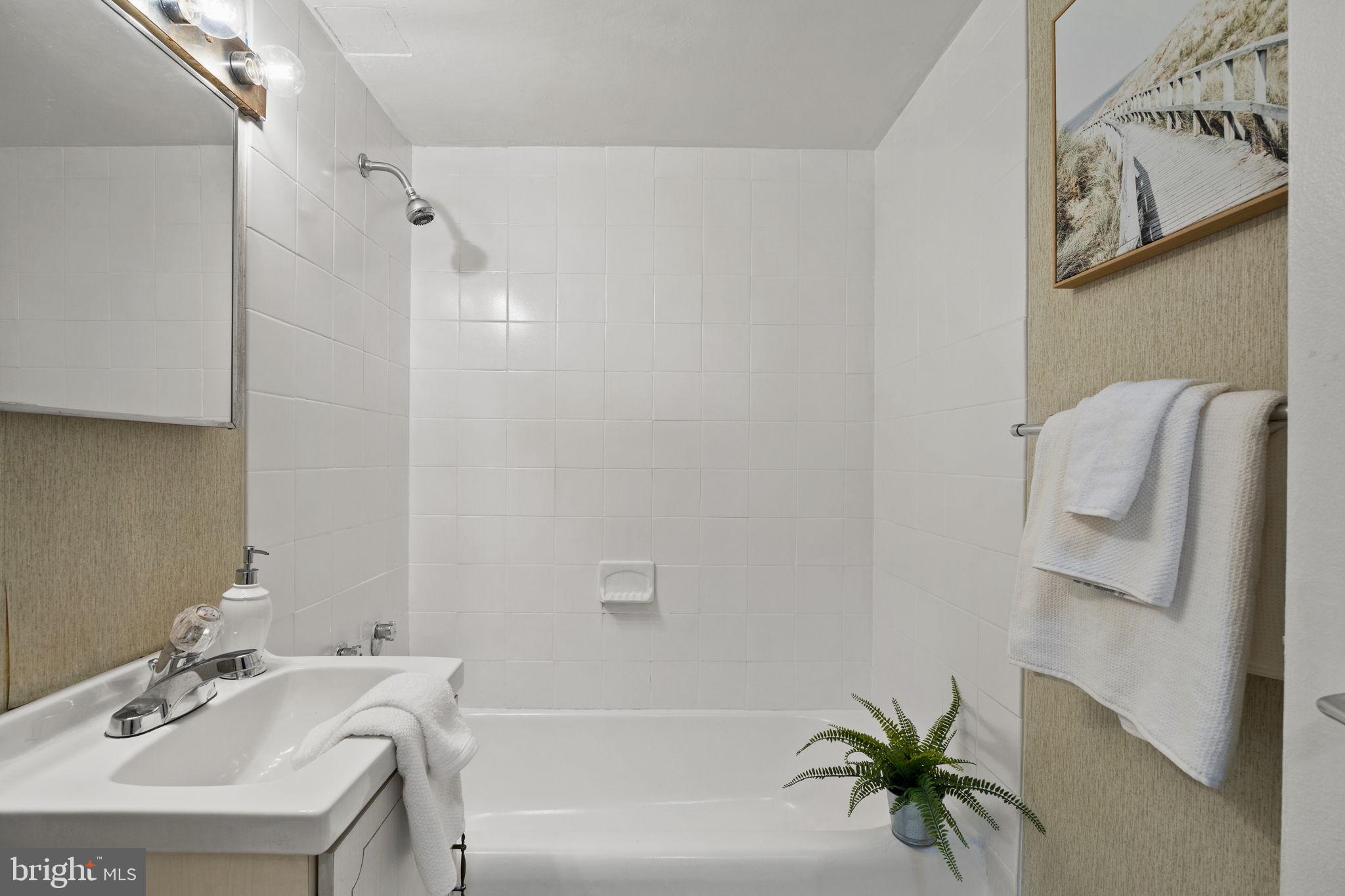 604 South Washington Square, Unit 913 Philadelphia, PA 19106 - Photo 14 of 24 a bathroom with a sink a mirror and a shower