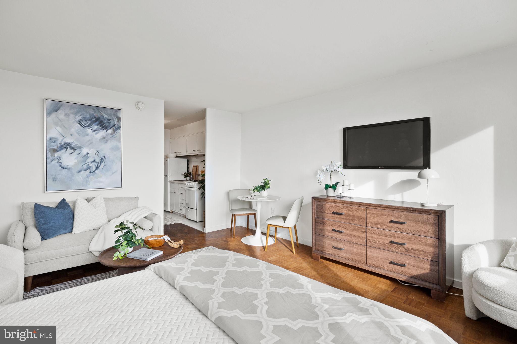 604 South Washington Square, Unit 913 Philadelphia, PA 19106 - Photo 7 of 24 a living room with furniture and a flat screen tv