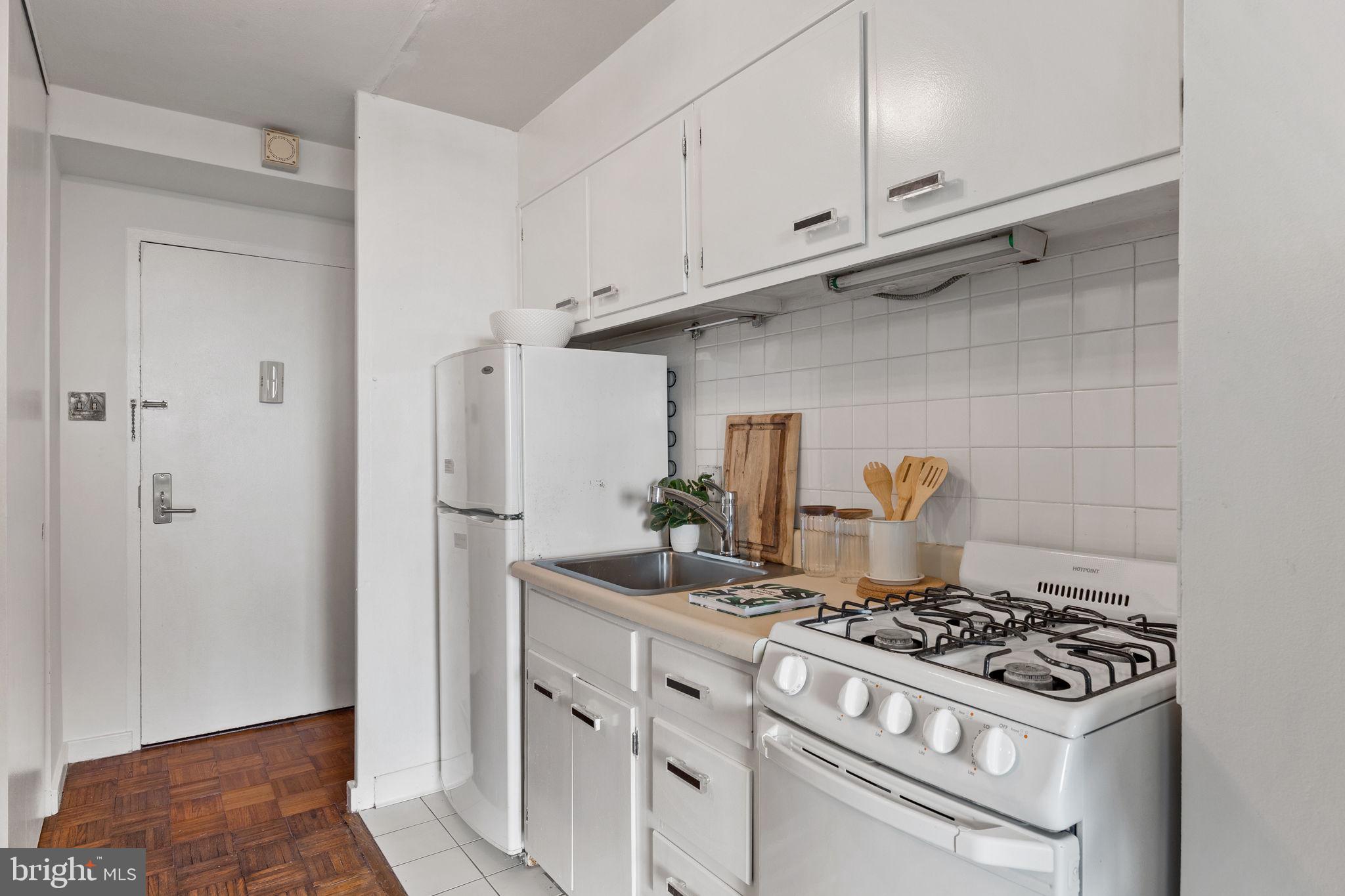604 South Washington Square, Unit 913 Philadelphia, PA 19106 - Photo 9 of 24 a kitchen with white cabinets and appliances