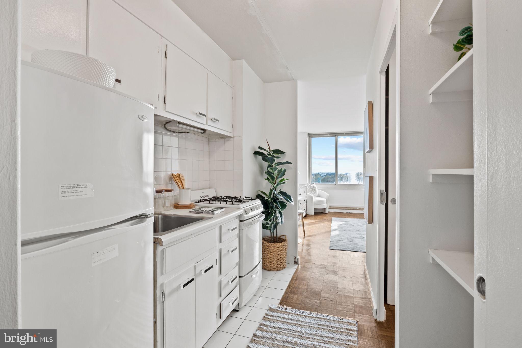 604 South Washington Square, Unit 913 Philadelphia, PA 19106 - Photo 10 of 24 a kitchen with white cabinets and appliances