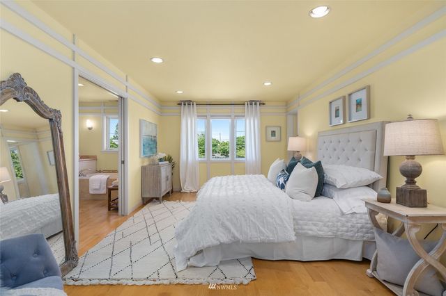 a bedroom with a large bed and a chandelier