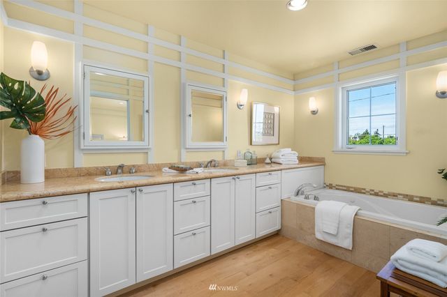 a spacious bathroom with a granite countertop sink mirror and