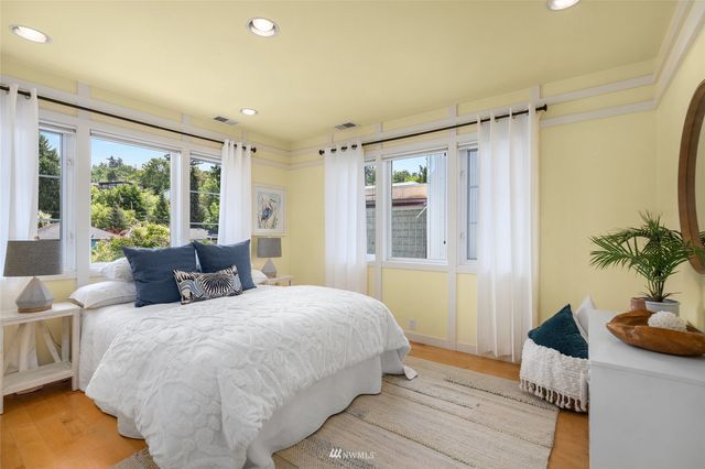 a bedroom with double bed and a potted plant