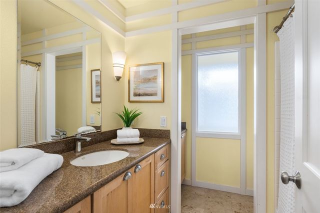 a bathroom with a granite countertop sink and a mirror