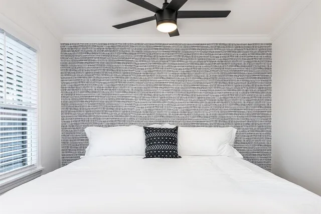 a bedroom with a bed and a window