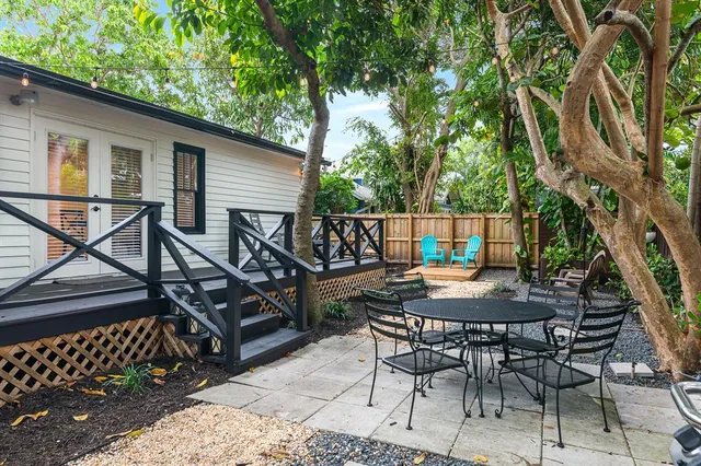 a view of a chairs and table on the wooden deck