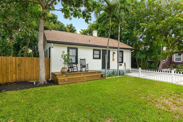 a view of a house with a yard and sitting area