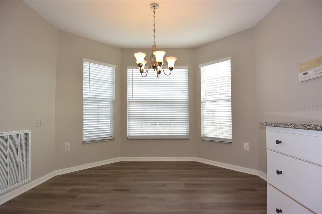 2339 Renton Lane Spring Hill, FL 34609 - Photo 12 of 35 a view of an empty room with wooden floor and a window