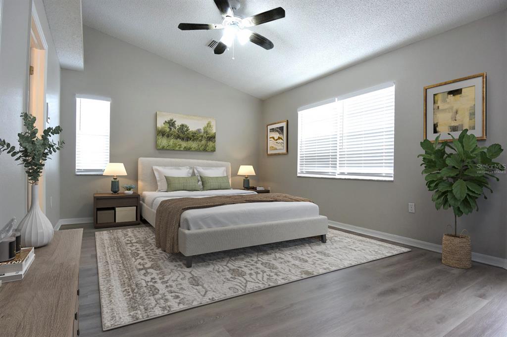 2339 Renton Lane Spring Hill, FL 34609 - Photo 14 of 35 a bedroom with a large bed and a window