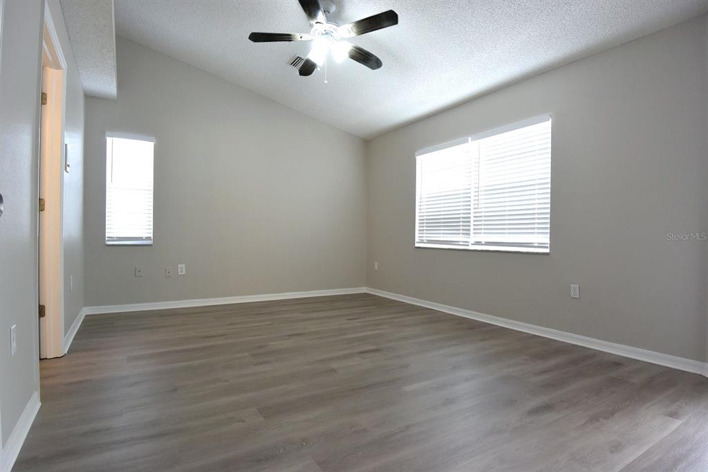 2339 Renton Lane Spring Hill, FL 34609 - Photo 15 of 35 a view of an empty room with a window and wooden floor