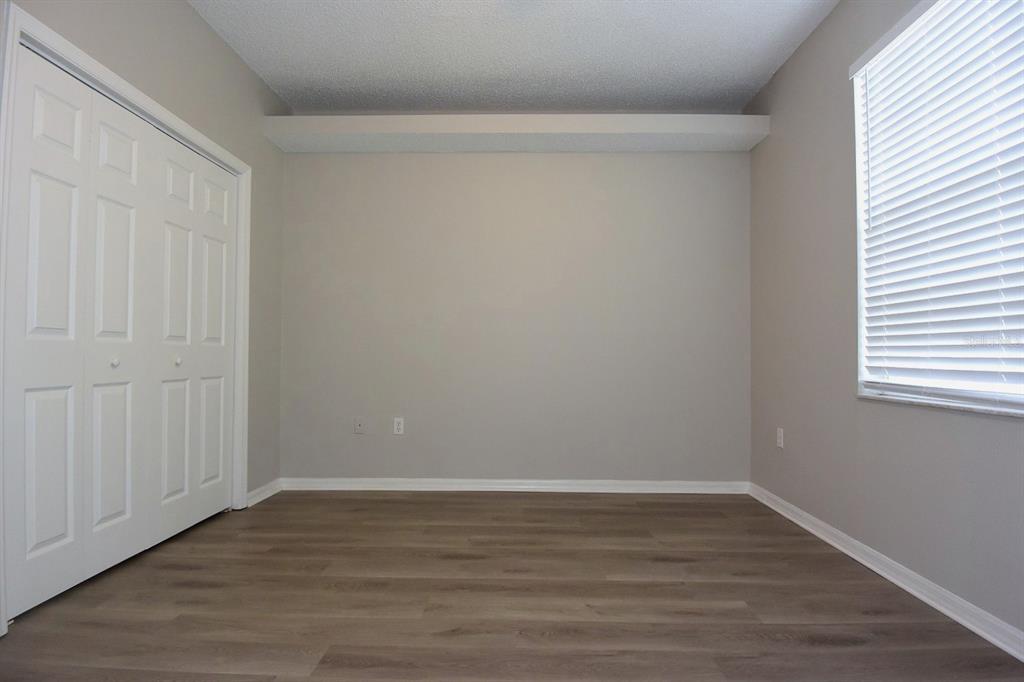2339 Renton Lane Spring Hill, FL 34609 - Photo 21 of 35 a view of an empty room with wooden floor and a window