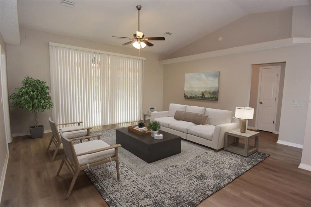 2339 Renton Lane Spring Hill, FL 34609 - Photo 3 of 35 a living room with furniture and a potted plant