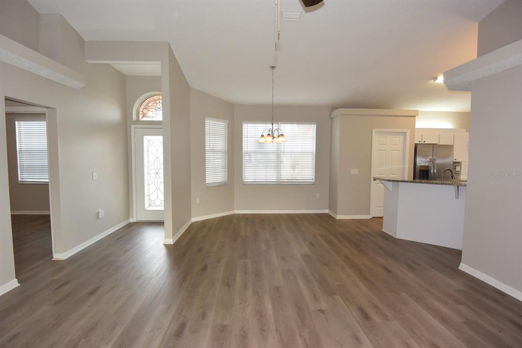 2339 Renton Lane Spring Hill, FL 34609 - Photo 6 of 35 a view of empty room with wooden floor and window