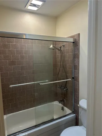 a bathroom with a shower and toilet