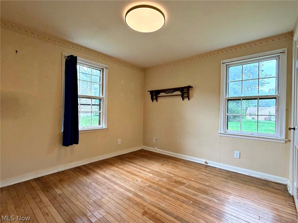 210 Callahan Road Canfield, OH 44406 - Photo 20 of 34 Two windows, wood-finish flooring, ceiling-mounted light fixture, decorative wall shelf, and crown molding