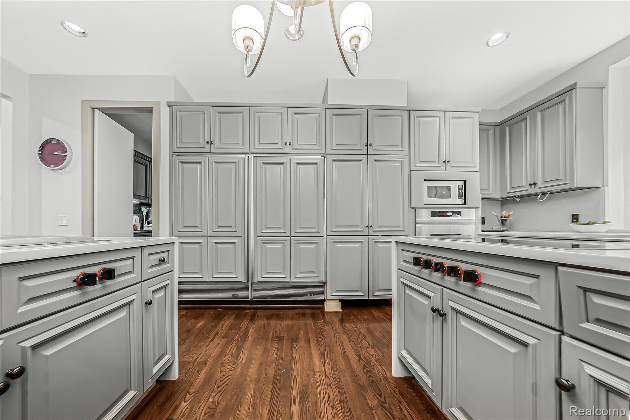 2785 Cranbrook Ridge Court Rochester, MI 48306 - Photo 47 of 99 Kitchen featuring wood-finish flooring, recessed lighting, a central chandelier, extensive light gray cabinetry, and integrated stainless steel appliances