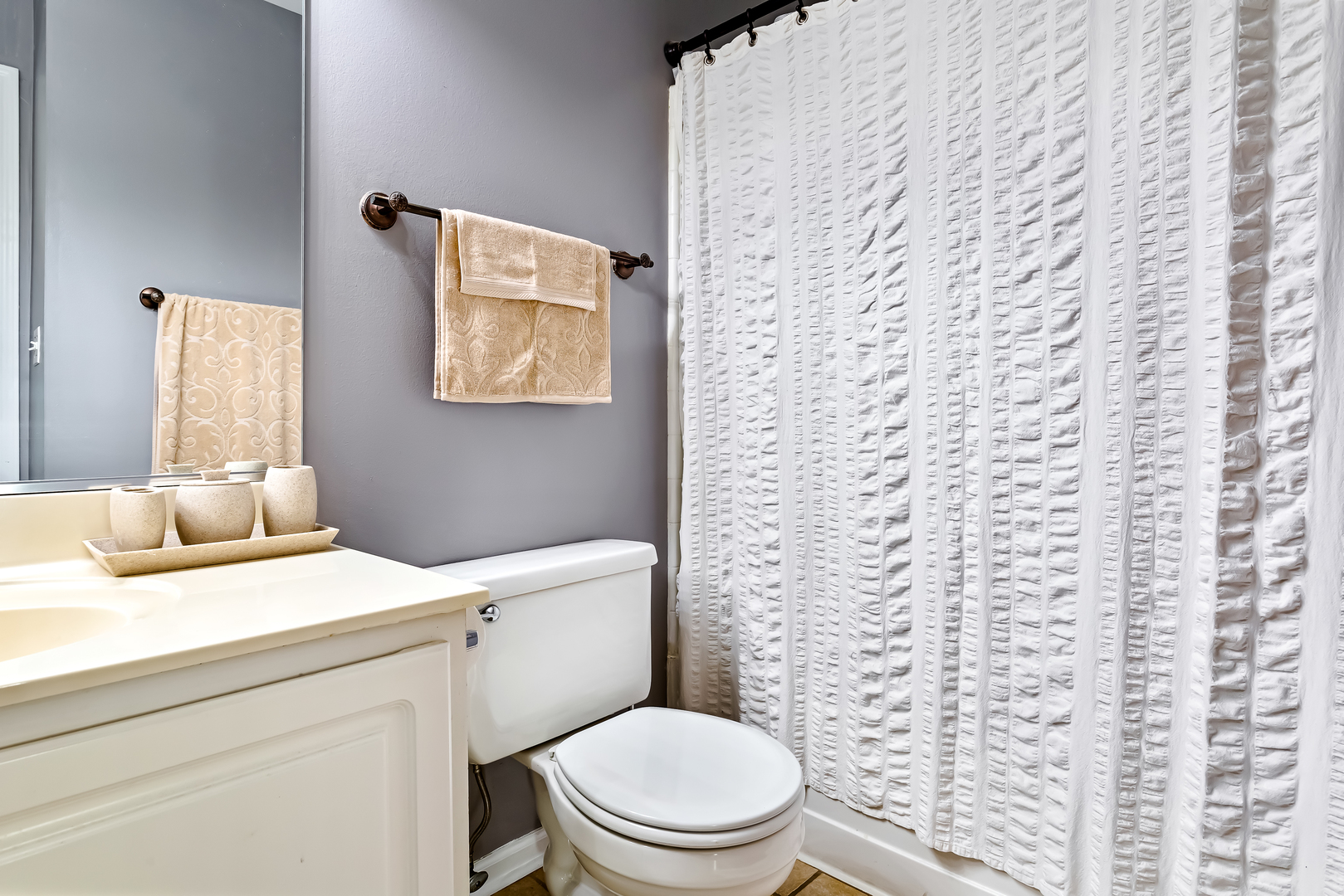 3389 Ravinia Circle, Unit 3389 Aurora, IL 60504 - Photo 11 of 23 a bathroom with a granite countertop toilet and a sink