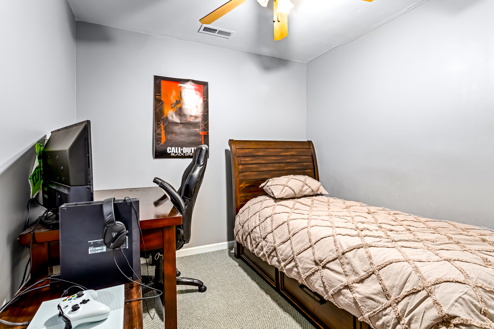 3389 Ravinia Circle, Unit 3389 Aurora, IL 60504 - Photo 13 of 23 a bedroom with a bed and a flat tv screen on a dresser