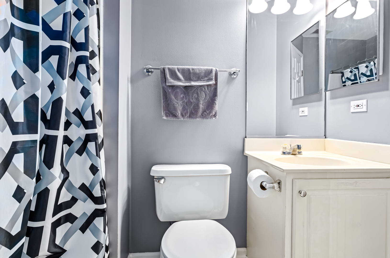 3389 Ravinia Circle, Unit 3389 Aurora, IL 60504 - Photo 14 of 23 a bathroom with a toilet sink and mirror