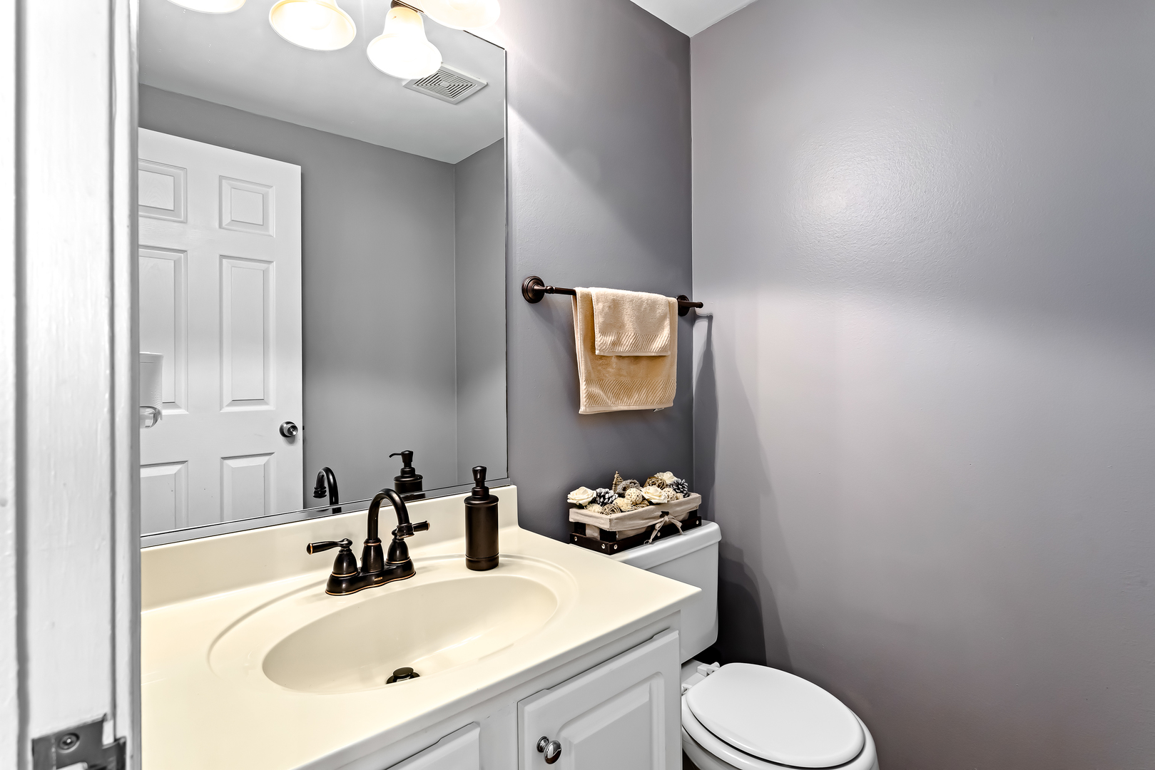 3389 Ravinia Circle, Unit 3389 Aurora, IL 60504 - Photo 15 of 23 a bathroom with a sink vanity mirror and toilet