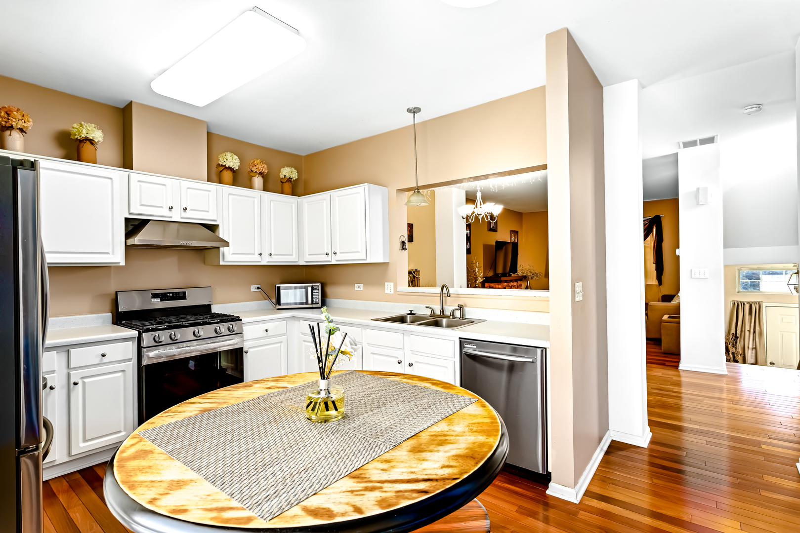 3389 Ravinia Circle, Unit 3389 Aurora, IL 60504 - Photo 5 of 23 a kitchen with a stove a sink and a refrigerator