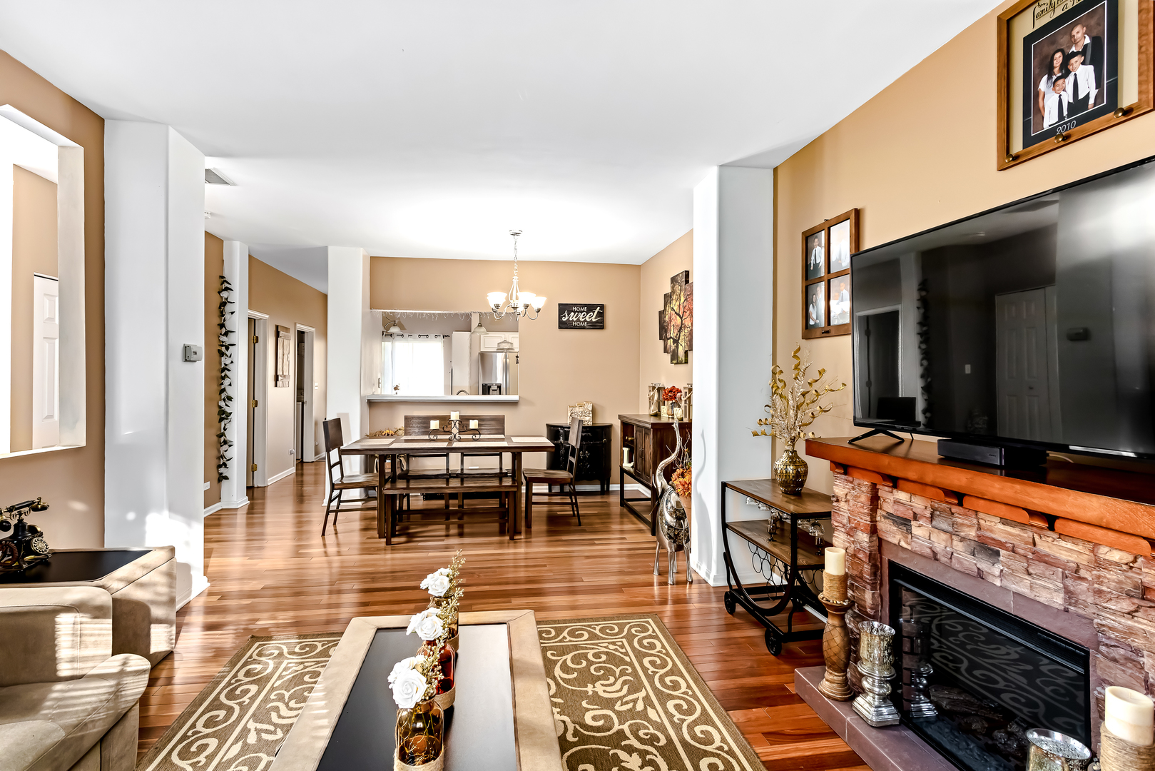 3389 Ravinia Circle, Unit 3389 Aurora, IL 60504 - Photo 7 of 23 a living room with dining room and kitchen view