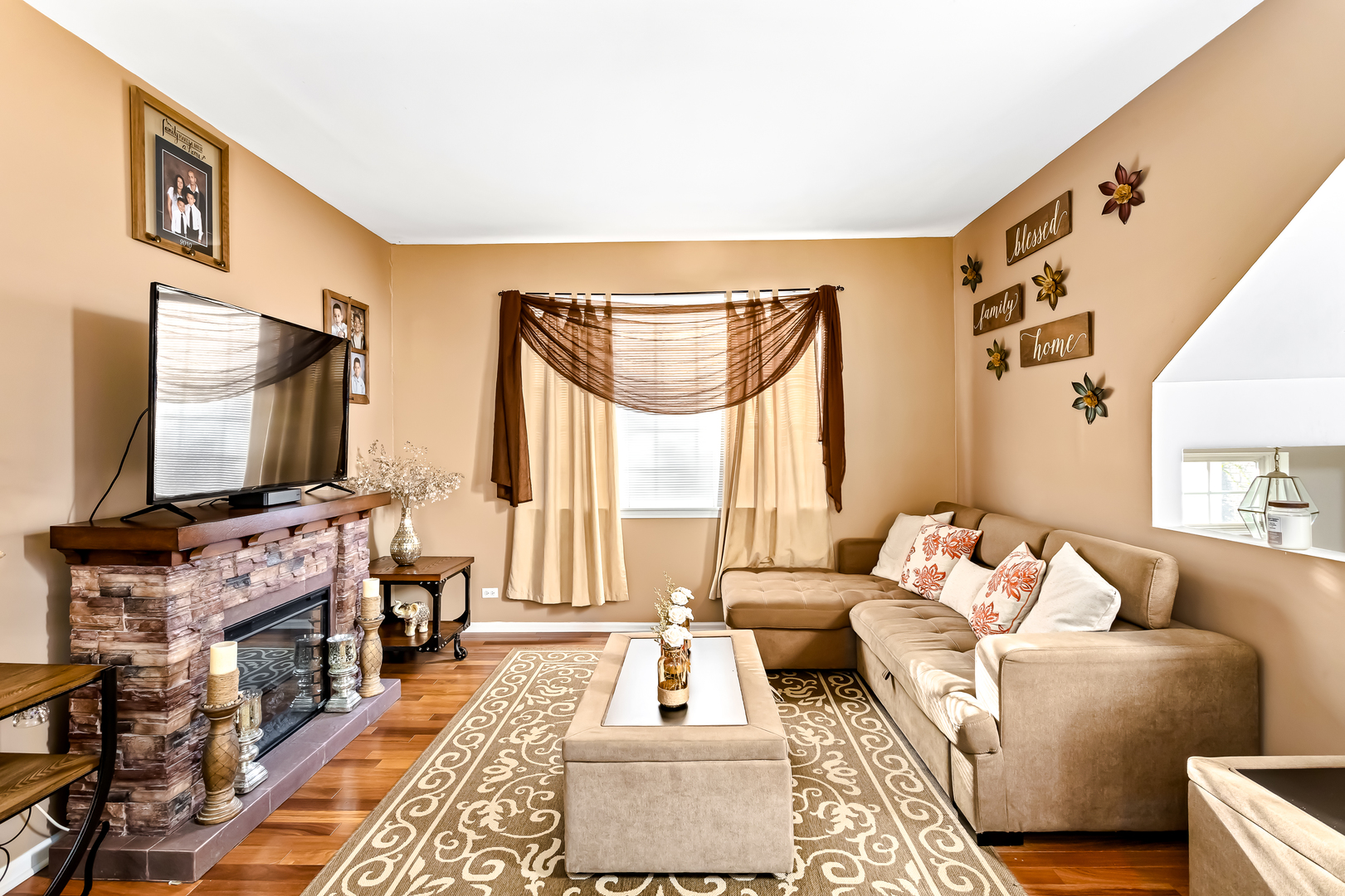 3389 Ravinia Circle, Unit 3389 Aurora, IL 60504 - Photo 8 of 23 a living room with furniture and a flat screen tv
