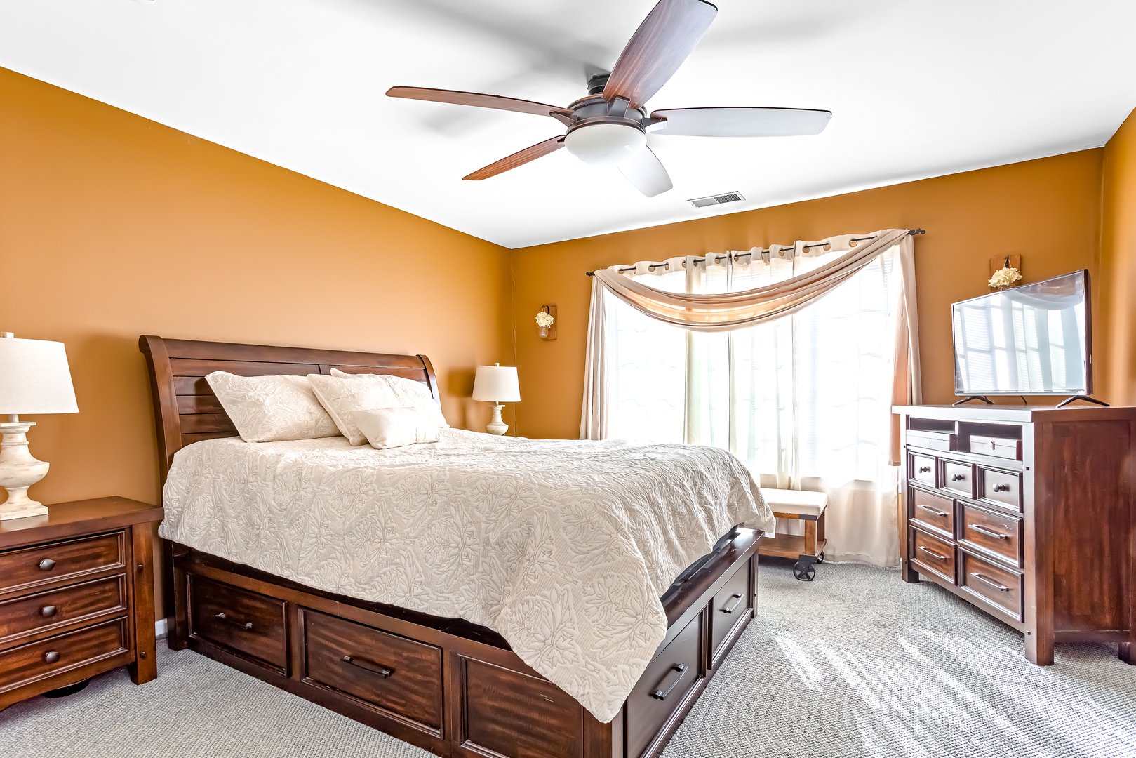 3389 Ravinia Circle, Unit 3389 Aurora, IL 60504 - Photo 9 of 23 a bedroom with a bed and a chandelier