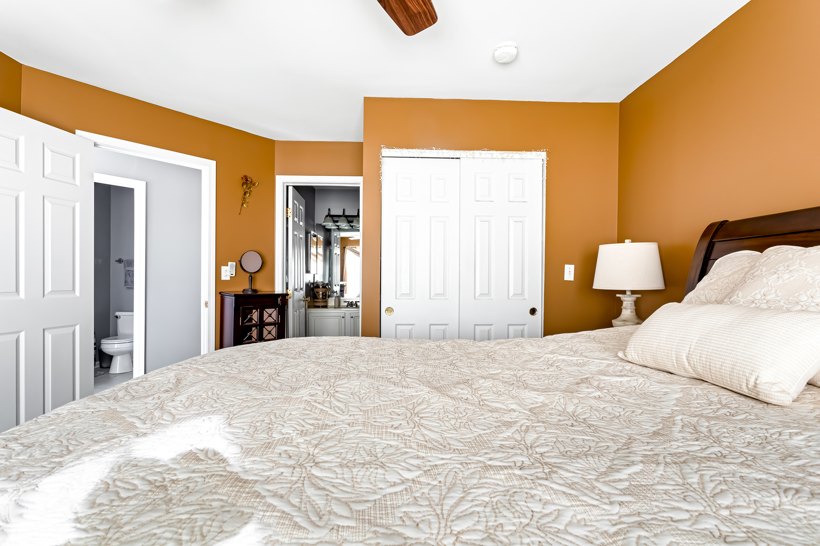 3389 Ravinia Circle, Unit 3389 Aurora, IL 60504 - Photo 10 of 23 a large bedroom with a bed and a large mirror