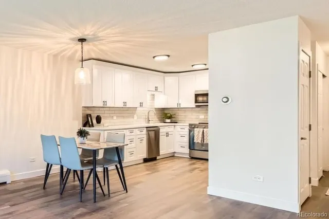 a kitchen with white cabinets and white appliances