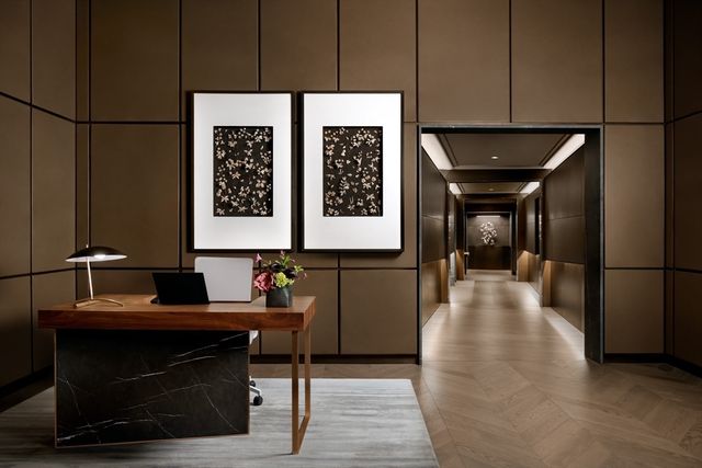 a hallway with a table and a chair