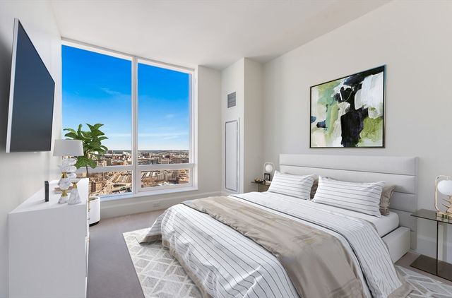 a bedroom with a large bed and a large window