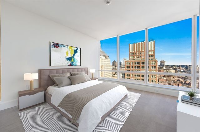 a bedroom with a bed and a wooden floor