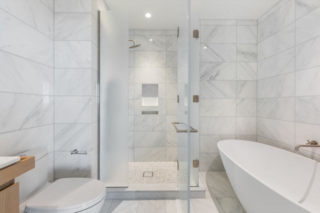 a bathroom with a toilet and shower