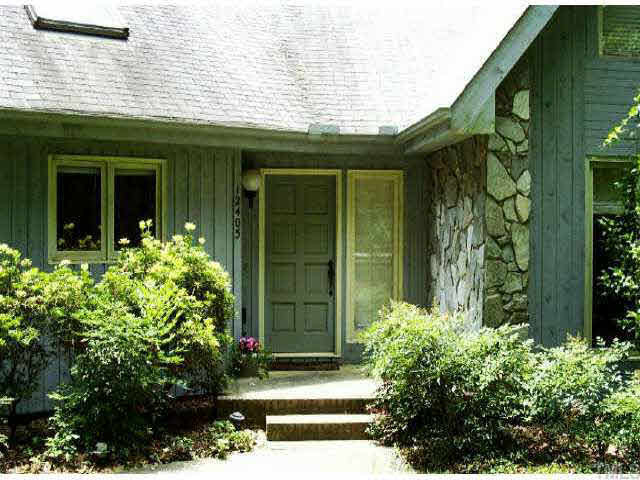 12405 Shooting Club Road Raleigh, NC 27613 - Photo 1 of 8 a front view of a house having garden