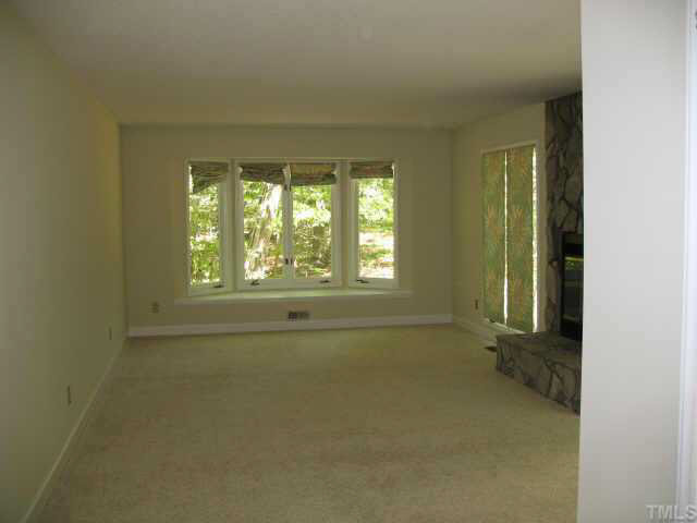 12405 Shooting Club Road Raleigh, NC 27613 - Photo 2 of 8 an empty room with a window