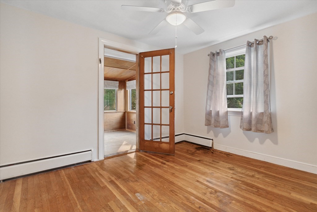 13 Surrey Road Salem, MA 01970 - Photo 18 of 42 an empty room with wooden floor and windows