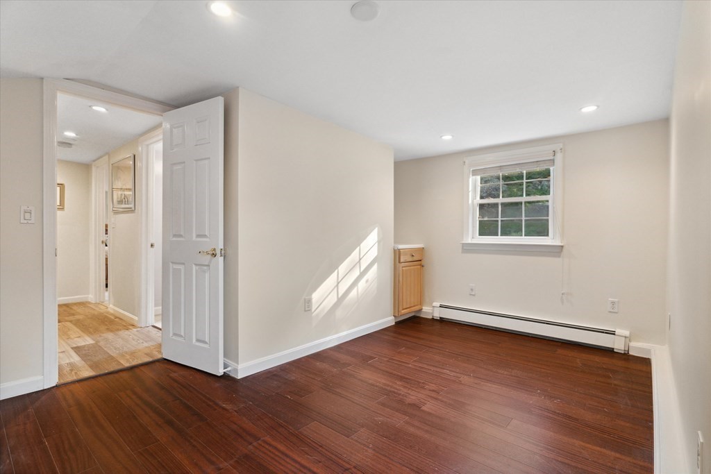 13 Surrey Road Salem, MA 01970 - Photo 24 of 42 an empty room with wooden floor and windows