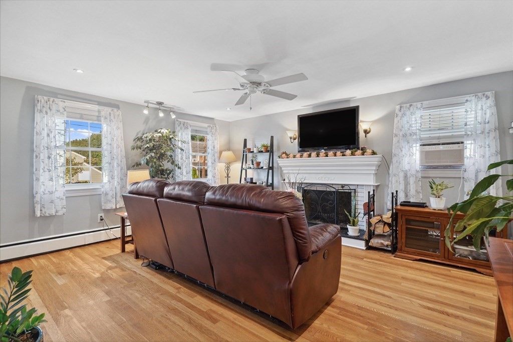 13 Surrey Road Salem, MA 01970 - Photo 6 of 42 a living room with furniture a flat screen tv and a fireplace