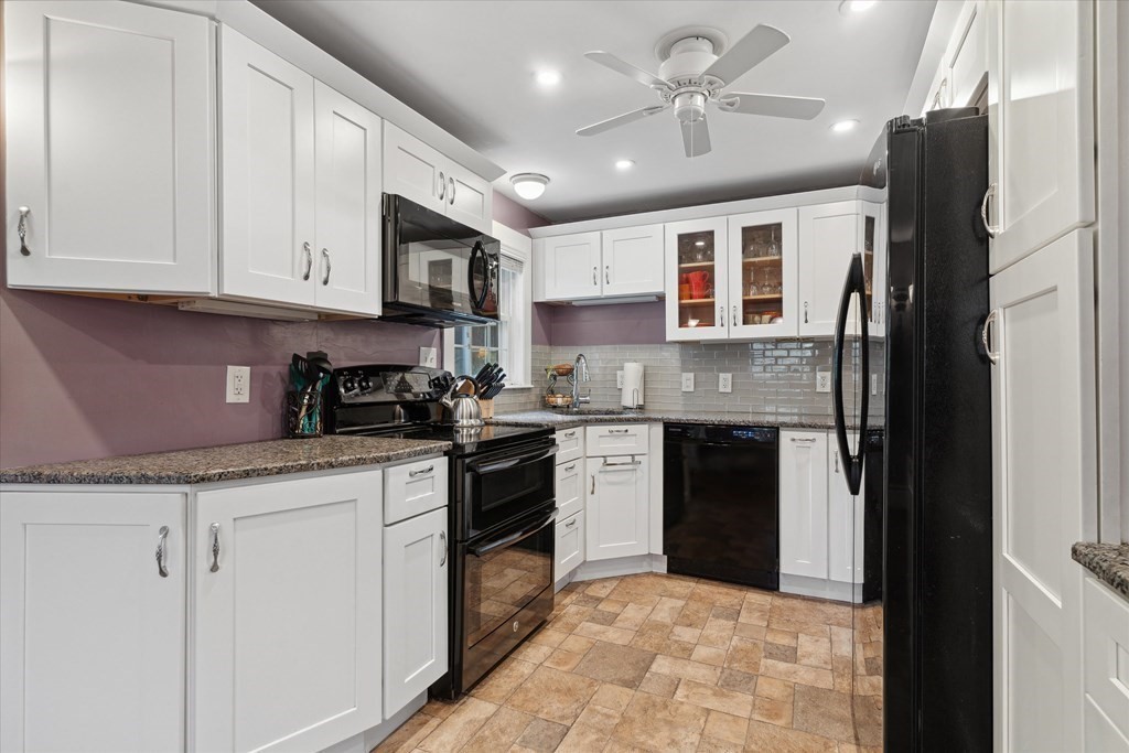 13 Surrey Road Salem, MA 01970 - Photo 10 of 42 a kitchen with stainless steel appliances granite countertop a stove sink and cabinets