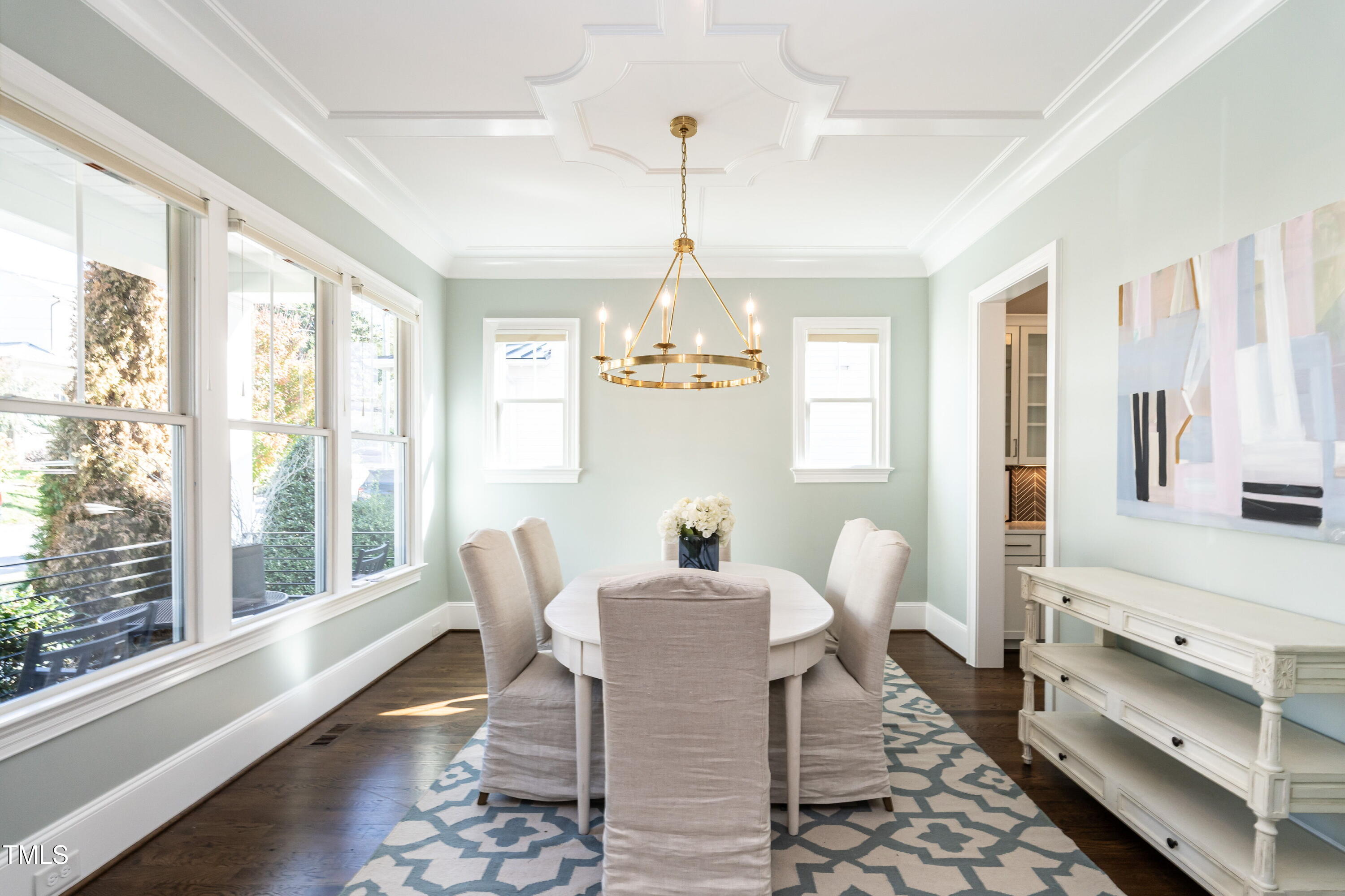 2705 Gordon Street Raleigh, NC 27608 - Photo 4 of 25 a dining room with furniture a chandelier and wooden floor