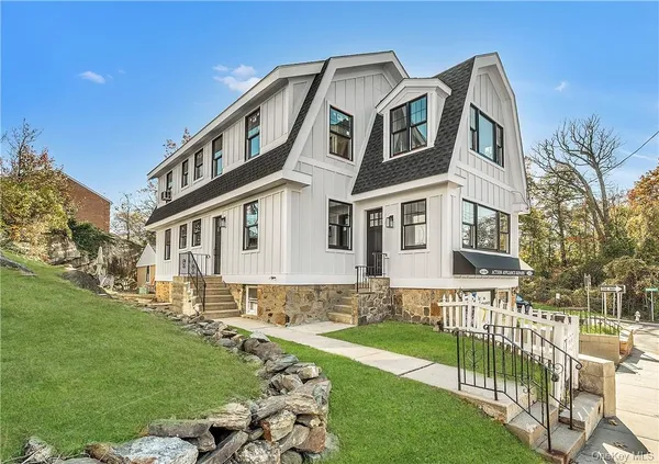 a front view of a house with a garden