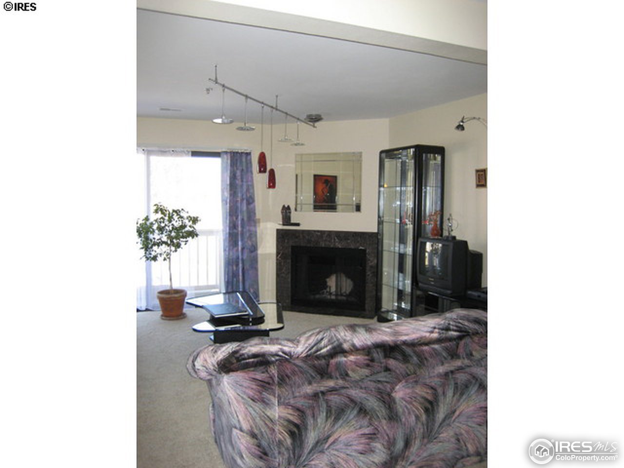 4965 Twin Lakes Road, Unit 64 Boulder, CO 80301 - Photo 2 of 6 a living room with furniture and a fireplace
